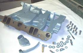 Bottom view of Pontiac intake manifold, pcv bracket and hardware in Poncho Blue